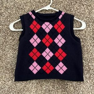 sweater vest pink and red and navy size M and hits at belly bottom